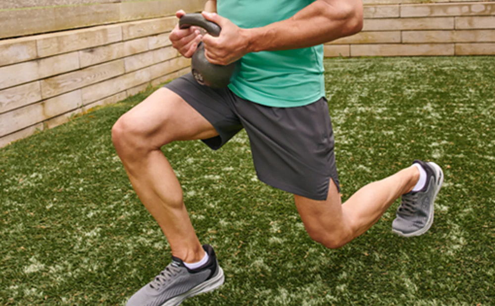 a runner stretching and bending down with a kettlebell