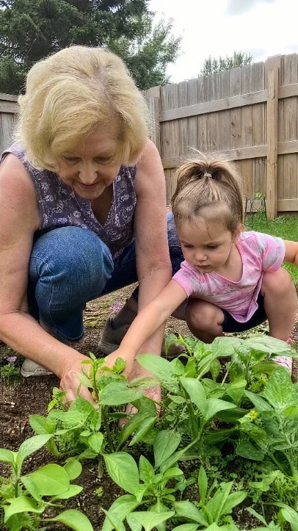 Customer gardening with her granddaughter